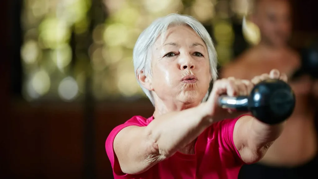 Toning Bingo Wings: Effective Exercises and Tips for Achieving Sleeker Arms 2 Person performing arm exercises with dumbbells West Thurrock
